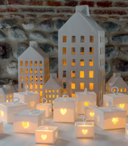 Candle and lights coming from big and small white lanterns made with paper by Scotton 